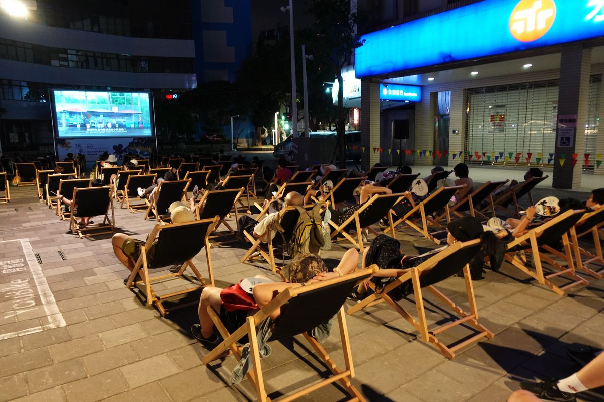 Audiences watch movie comfortably on deck chairs.